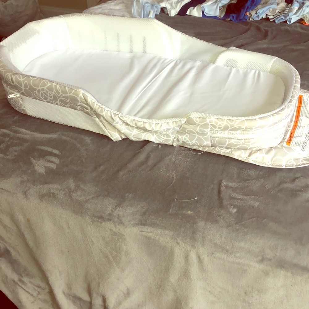 Snuggle nest portable infant sleeper